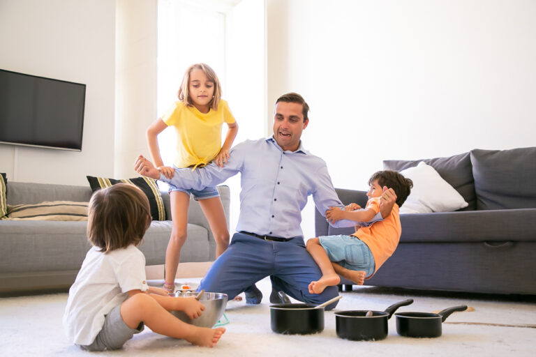 happy caucasian man playing with children showing strength cheerful kids having fun together living room carpet pans bowl game childhood weekend home activity concep